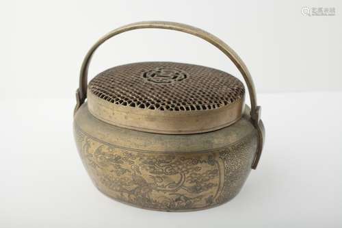 A Chinese bronze hand warmer with reticulated lid,