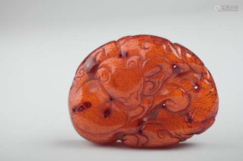 A Chinese chilong carved amber plaque,