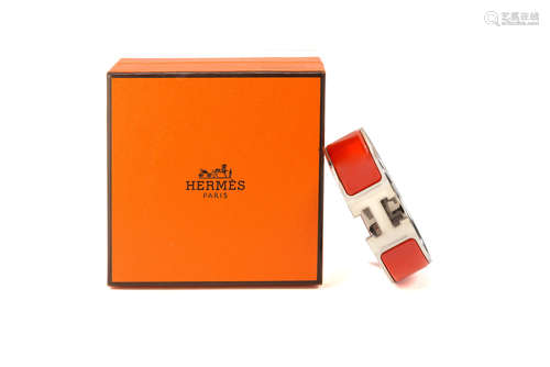 HERMESOrange and ivory enamel logoed metal bracelet, with original box and guarantee