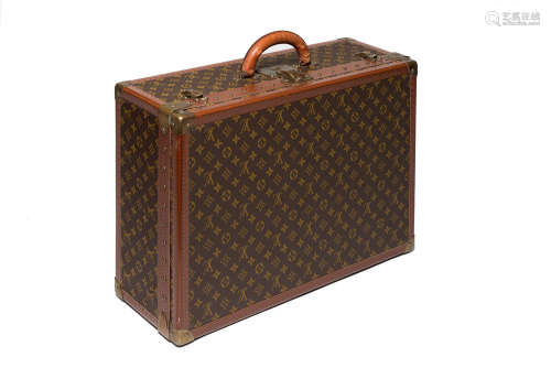 LOUIS VUITTONMonogram canvas rigid suitcase and cowhide profiles, brass details mis. cm 60x41x21