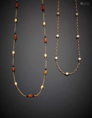 Two yellow gold long chain necklaces with carnelian the first and pearls the second, in all g 51.21.