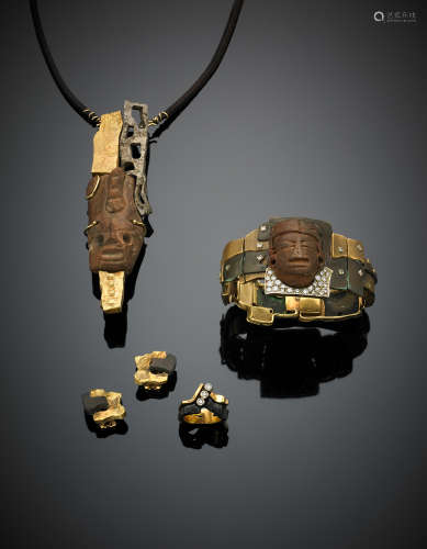 FREDDI BRUNOParure composed of a necklace, a pendant, a bracelet, a ring and earrings: -Yellow gold, silver and leather necklace with a terracotta reproduction of a pre-Columbian head 1980 -Bi-coloured gold and copper diamond bracelet with a reproduction of a Maya head 1979 -Yellow gold and burnished copper earrings 1981 -Bi-coloured gold, iron and diamond ring 1981, in all g 126.50.