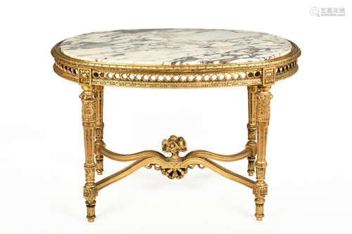 LOUIS XVI GILTWOOD CARVED OVAL SHAPED MARBLE TOP SALON TABLE WITH FLORAL FILLED URN MOUNTED STRETCHER