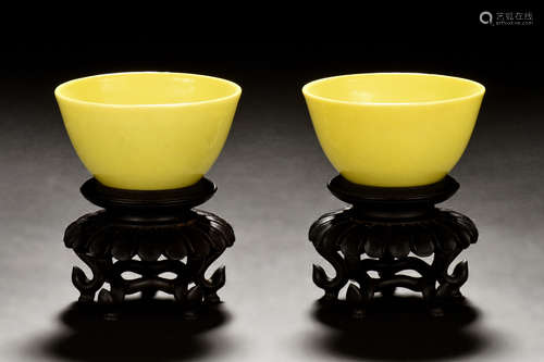 PAIR OF LEMON YELLOW GLAZED CUPS WITH WOODEN STANDS