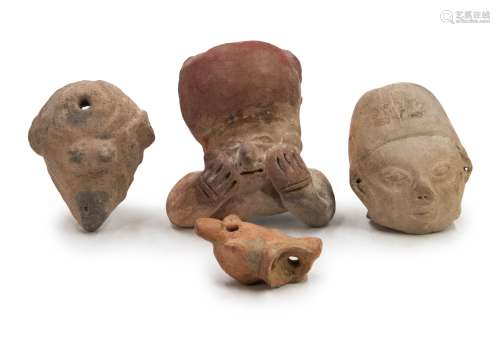 POTTERY GROUP OF HEADS AND A WHISTLE