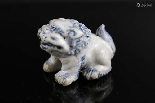 Japanese porcelain netsuke of a foo dog.