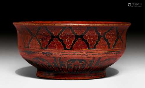A LACQUERED WOODEN BOWL ON A SHORT FOOT WITH BORDERS OF CLOUDS AND STYLIZED LEAVES. Tibet, Amdo, ca. 16th c. D 22.5 cm. Minor rubbing.