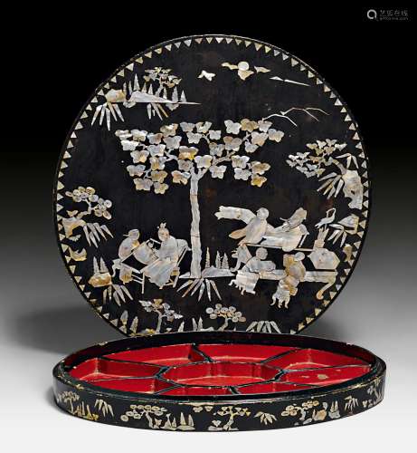 A LARGE BLACK LACQUER BOX WITH MOTHER OF PEARL INLAY DEPICTING FIGURES IN A GARDEN LANDSCAPE, AND CONTAINING NINE RED LACQUER BOWLS.