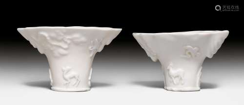 A PAIR OF BLANC DE CHINE RHINOCEROS HORN BEAKERS WITH RELIEF DECORATION OF ANIMALS IN A GARDEN LANDSCAPE. China, Kangxi Period, H 9 cm. (2)