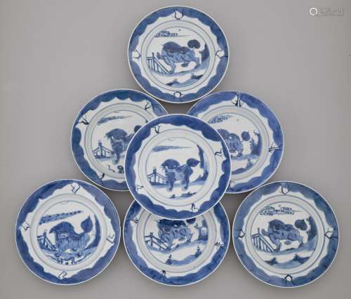 SEVEN BLUE-AND-WHITE PLATES WITH A LION IN A GARDEN LANDSCAPE. China, Kangxi Period, D 21.5 cm. Underglaze blue conch shell mark in a double ring. Minor damage. (7)