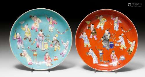 TWO PLATES WITH DECORATION OF CHILDREN.China, Republic, D 23.5 cm. Decorated in famille rose colours with boys at play on turquoise and red grounds respectively. Exteriors with seven children and Buddhist emblems. Iron red Jiaqing mark. Slightly rubbed. (2)