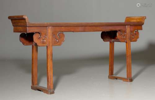 AN ALTAR TABLE WITH ROLLED-UP ENDINGS.