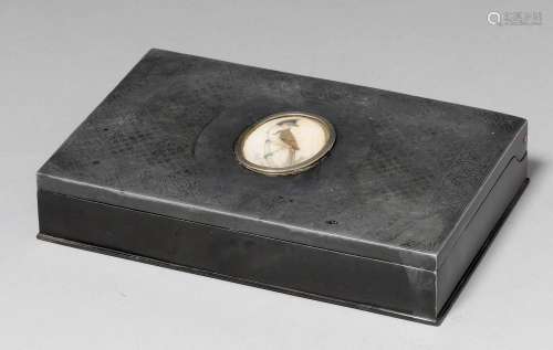 A METAL CIGARETTE BOX WITH SILVER INLAY AND IVORY MEDALLION. Iran, 20th c. 10.5x16.8x3.5 cm. Wood lining.