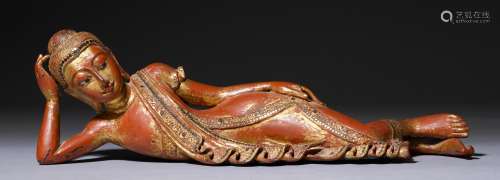 A SMALL LACQUERED WOOD FIGURE OF A RECUMBENT BUDDHA, WITH STONE INLAYS. Burma, Mandalay, L 51 cm. Minor chips.