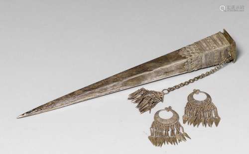 A SILVER EARRING AND HAIRPIN. Southeast Asia, Hmong culture, L 6.3 cm & H 27 cm. Hairpin on stand. (3)