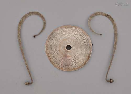 A SILVER FIBULA AND TWO SILVER PENDANTS FOR A HEAD ORNAMENT. Southeast Asian, Akha culture, D 13.3 cm and L 21 cm. (3)