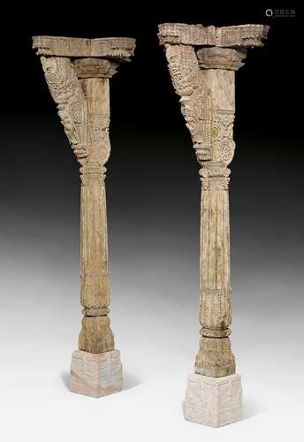 A PAIR OF CARVED SIX-PART WOOD COLUMNS.