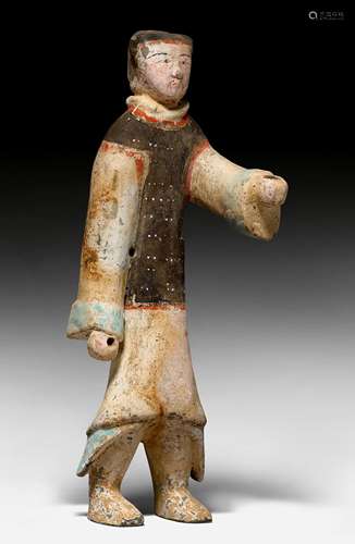 A PAINTED POTTERY FIGURE OF A SOLDIER.