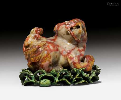 A CHICKEN-BLOOD SOAPSTONE CARVING OF A LION.