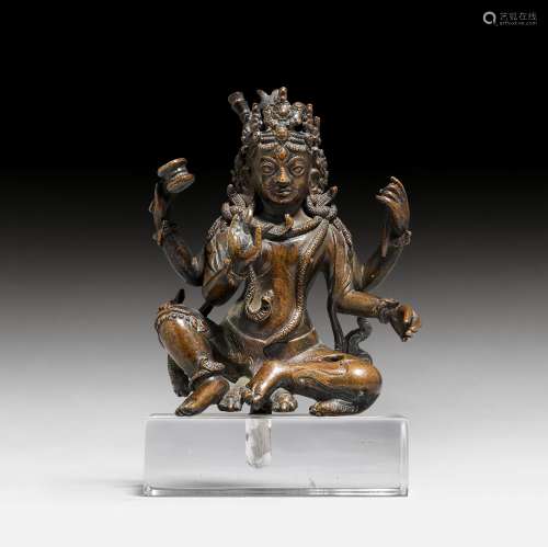 A COPPER ALLOY FIGURE OF THE FOUR ARMED SHIVA.