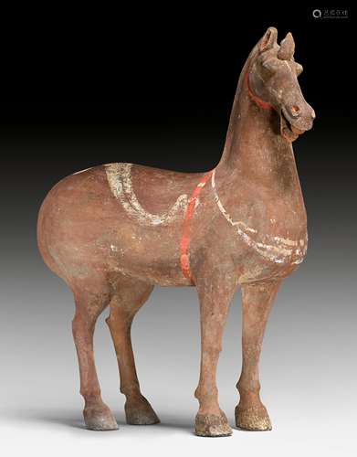 A BROWN PAINTED POTTERY HORSE.