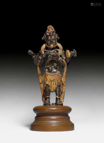 A PARTLY LACQUER-GILT BRONZE FIGURE OF THE FOUR ARMED MAHAKALA.