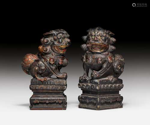 A PAIR OF LACQUERED STONE LIONS.