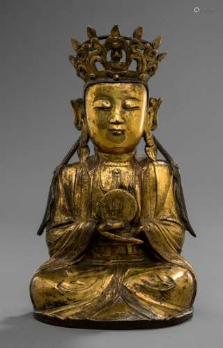 A GILT-BRONZE FIGURE OF GUANYIN HOLDING A SUN PLAQUE