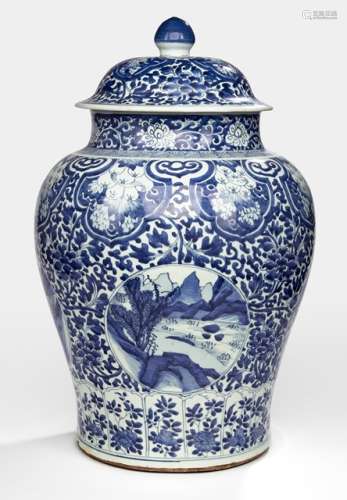 A LARGE VASE AND COVER WITH LANDSCAPE DECOR IN CARTOUCHES ON FLORAL GROUND