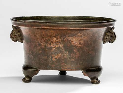 A BRONZE TRIPOD CENSER WITH MASK HANDLES