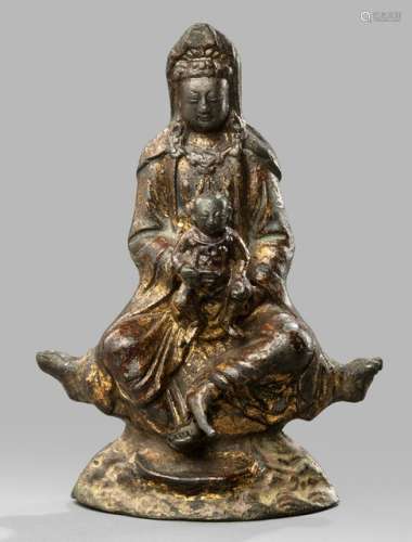 A GILT-LACQUERED BRONZE FIGURE OF GUANYIN AND CHILD SEATED ON A ROCK