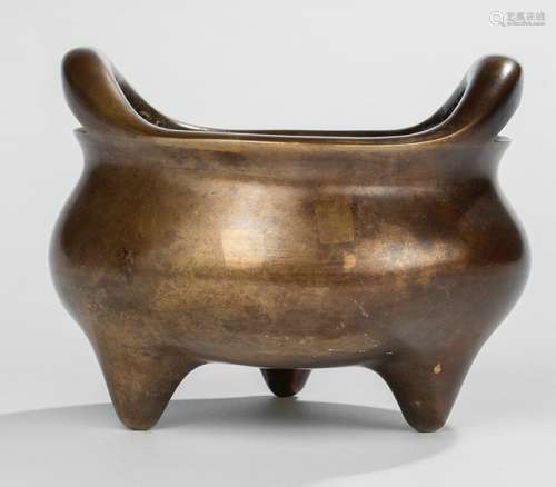 A BRONZE CENSER WITH TWO HANDLES ON THREE SHORT LEGS