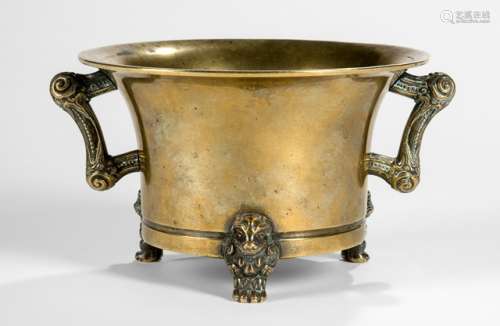 A GOLD-COLORED BRONZE CENSER WITH TWO HANDLES ON THREE FEET