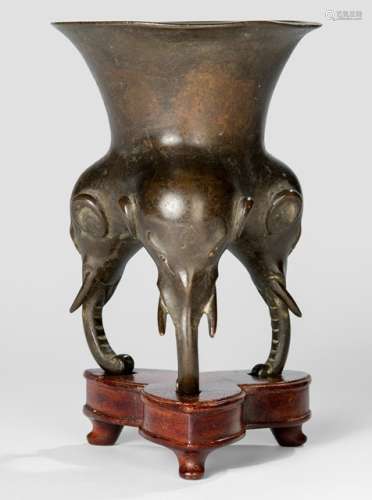 A BRONZE CENSER WITH ELEPHANT-HEAD LEGS ON A WOODEN STAND