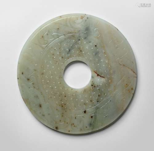 A FINELY CARVED JADE 'BI' DISC WITH STYLIZED PHOENIX DECOR ON BOTH SIDES