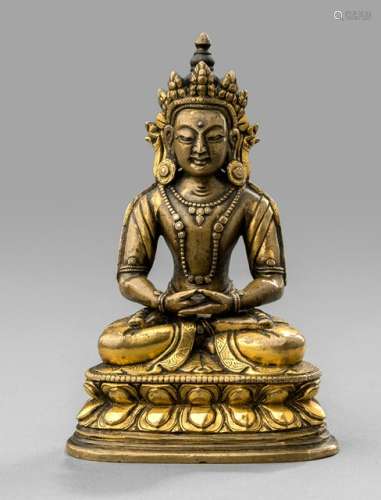 A PARCEL-GILT BRONZE FIGURE OF AMITAYUS, Tibeto-Chinese, 18th ct. Seated in vajrasana on a lotus base with both hands in dhyanamudra originally supporting the kalasha, wearing dhoti, bejewelled, his face displaying a serene expression with downcast eyes below arched eyebrows, urna and his hair combed into a chignon secured with a tiara, unsealed - Provenance: Property from an important German private collection - Minor wear