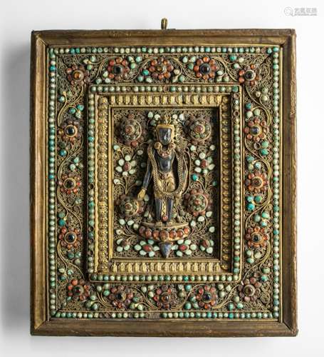 A PART-GILT COPPER PANEL WITH ELABORATE STONE INLAYS AND BODHISATTVA IMAGE, Nepal, ca., 1900 - Property from the estate of a North German private collector, assembled until 1999, by descent to the present owner - Few losses to inlaid stones, very slightly chipped