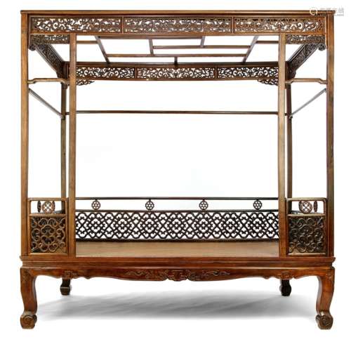 A HARDWOOD CANOPY BED WITH PIERCED AND CARVED APRONS, China 18th Ct. - Cf: Wang Shixiang and Curtis Evarts: Masterpieces from the Museum of Classical Chinese Furniture, 1995, page 20/21, no. 10 - Property from a Scandinavian private collection, acquired before 1990 - Two front stands replaced, left hand front carving replaced, five medallions replaced, a number of carvings have been replaced