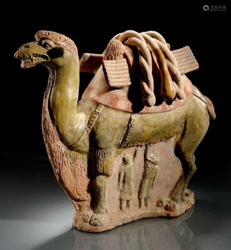 A GREEN-BROWN GLAZED POTTERY GROUP OF A CAMEL WITH A CALF, China, Sui/ Tang dynasty, 7th ct. Standing on a flat base, the head held erect, the mouth opened, the ears sticking out. With a saddlecloth fastened around the neck, the belly and back with buckled straps, loaded with a blanket. The space between the legs is solidly modelled and moulded in relief, showing on one side a suckling calf, on the other two small figures each with a raised arm. Unglazed areas partly painted in dark red. The base is pierced with three large holes. Age measurement confirmed by Thermoluminescence Analysis (Oxford Authentication, no. C103a92). - Provenance: Bought in 2000 from L.H.W. Investment & Trading Limited, Hong Kong. - Described and illustrated in: Regina Krahl: Collection Julius Eberhardt. Early Chinese Art, vol. 2, Hong Kong 2004, p. 66f.
