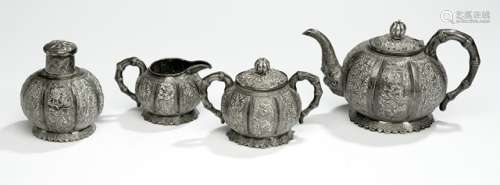 A FOUR-PART SILVERWARE TEA SET, China, late Qing dynasty, marked Tu Mao Xing, Jiujiang. Each piece in a lobed shape, decorated with bamboo, prunus blossoms, and literary scenes, with handles shaped like bamboo branches, the teapot's spout issuing forth from a dragon's mouth. - Property from a Dutch private collection, acquired in Europe before 1990 - Very slightly dented, minor wear