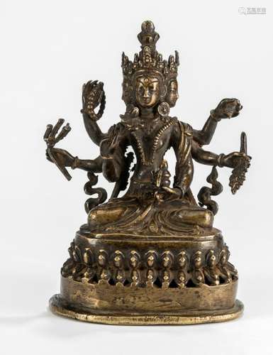 A BRONZE FIGURE OF USHNISHAVIJAYA, Nepal, 18th/19th ct. Seated in padmasana, with three heads and six arms, each hand holding an attribute. The left hands holding manuscript, grain spike and elixir ewer, the right hands holding rosary, trisula, and lotus blossom. With incense holders fitted to the back of the lotus base. - Former property from an old German private collection - Minor wear