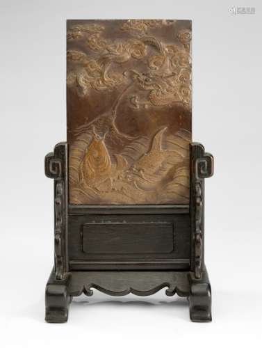 A DRAGON AND FISH DUAN STONE MOUNTED AS A TABLE SCREEN, China ca. 18th ct., the stand later - Property from an Austrian private collection, assembled in the 1980s and 90s - Upper edge very slightly chipped