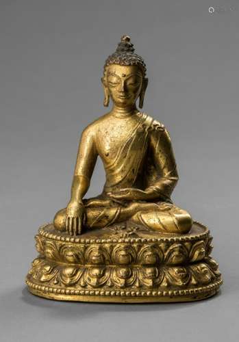A GILT-BRONZE FIGURE OF BUDDHA AKSHOBHYA, TIBET, 17th/18th ct. Seated in vajrasana, dressed in a long draped robe, his hands in bhumisparshamudra, a small vajra placed on the base in front of him. - Former property from an Austrian private collection - Bowl lost, minor wear