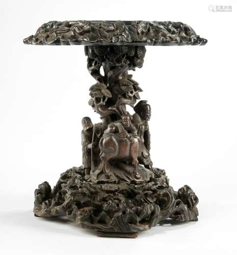 A HARDWOOD STAND WITH CARVING OF AN OLD SCHOLAR WITH A BOY ON A BUFFALO, China, late Qing dynasty - Former property from a South German private collection, acquired in the 1960s - Traces of age