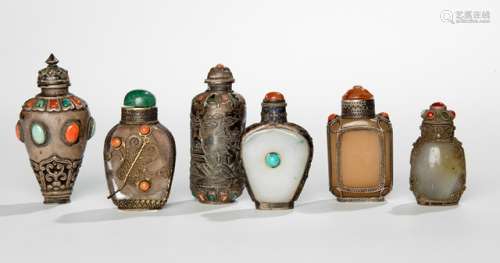 A GROUP OF SIX SILVER AND SILVER-MOUNTED SNUFF BOTTLES, China/Mongolia, 19th/early 20th ct. - Inset with coral and turquoise, the silver mounted bottles made with bodies of jade or rock crystal - Property from an old Diplomate collection, assembled in China prior 1970 - Few insets lost, partly dents