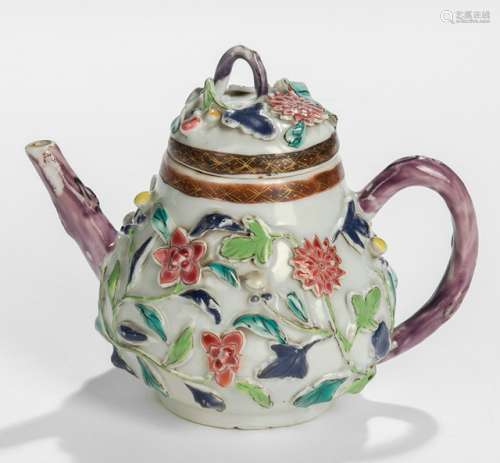 A SMALL PORCELAIN TEAPOT WITH FLORAL ENAMEL DECOR IN RELIEF, China, Yongzheng/Qianlong period. - Property from an old Belgian private collection, assembled between 1890 and 1940, by descent to the present owner - Minor wear, minor losses to enamel at the handle