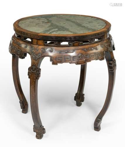 A ROUND HARDWOOD TABLE WITH STONE PANEL, China, late Qing dynasty. The round stone panels set within a round frame, with meandering decor on the outside rim. The apron partially in openwork and archaistic cloud decor. The legs curved to the bottom and straight feet. - Property from an old German private collection, assembled prior to 1990 - Minor age cracks and nicks, very minor scratch to the panel surface