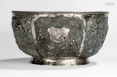 A LARGE SILVER BOWL DECORATED IN THE TYPICAL MANNER OF CHINESE EXPORT SILVER, China, late Qing dynasty/Republic period, stamped CS - Repoussé work, circular shape on slightly everted foot rim, the decoration composed of six panels with various pattern including an uninscribed coat of arms - Property from a German private collection - Few small dents, minor wear