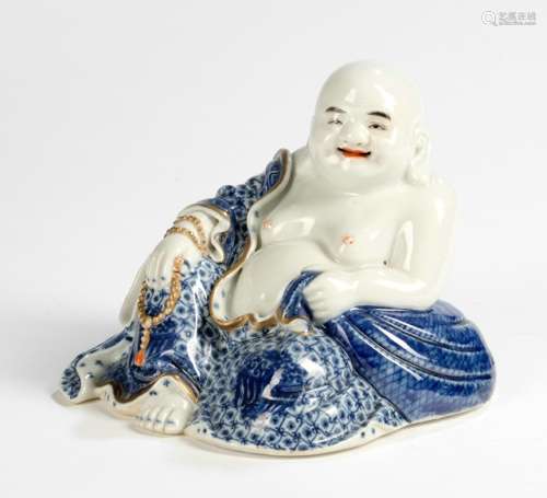 A BLUE AND WHITE DECORATED AND GILT-PAINTED PORCELAIN MODEL OF SEATED BUDAI, China, marked, Republic period - Provenance: Former old North German private collection - Very minor wear