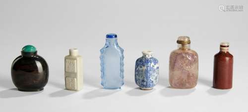A GROUP OF SIX SNUFF BOTTLES MADE OF PORCELAIN, GLASS AND AMETHYST, China, late Qing period, one snuff bottle marked 'Yongzheng nian zhi'- Property from an old Bavarian private collection, assembled by the father of the present owner till the 1980s - Traces of age, some stoppers lost